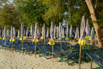 Beach deck chairs and umbrella in the morning at Cha-am Beach.  Located at Phetchaburi Province in...