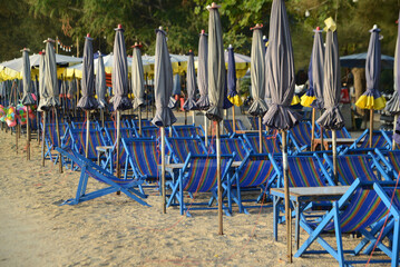 Beach deck chairs and umbrella in the morning at Cha-am Beach.  Located at Phetchaburi Province in...