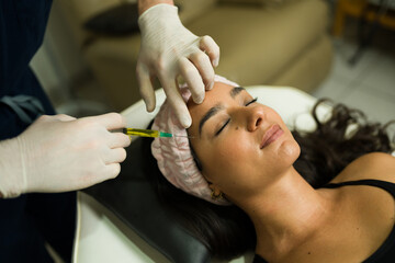 Beautiful woman looking relaxed getting plasma PRP treatment - 778536083