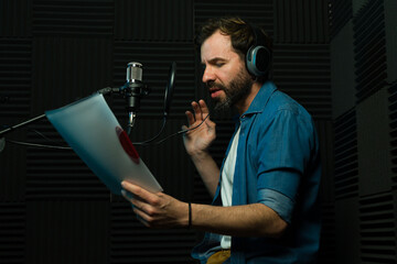 Voice actor recording audio in studio - 778537443