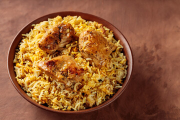 Indian Traditional Chicken Biryani Rice in Bowl on Brown Background, Copy Space