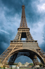 The Eiffel tower in Paris, France, against dramatic skies.