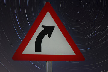 A road sign indicating a right turn with star trials in the background.  Abstract road safety concept. 