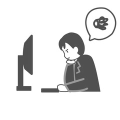 PCの前で肘をついて不機嫌そうな男性会社員