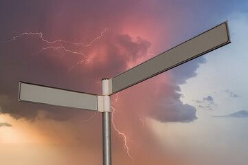 A blank signpost against a thunderstorm background.  Copy space provided om signpost.