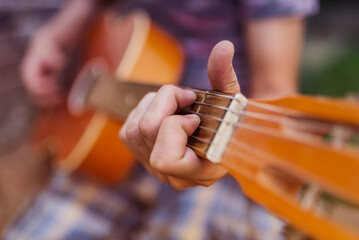 Close Up Of Guitarist Hand Playing Guitar. Musical And Instrument Concept. Outdoors And Leisure...