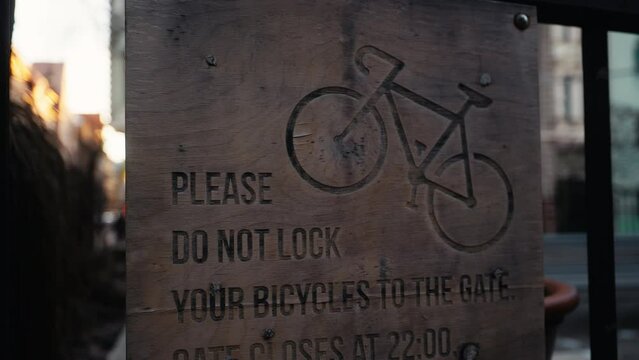 Do not attach bicycles to gate, use bike rack nearby