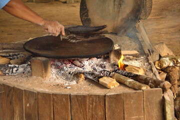Pan for making yuca bread on a fire in Puerto Bolivar in the Cuyabeno Wildlife Reserve, outside of Lago Agrio, Ecuador - obrazy, fototapety, plakaty