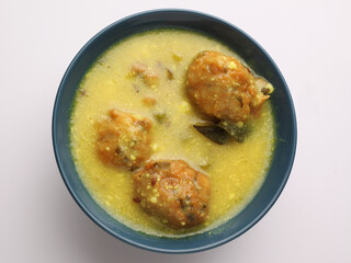 Kadhi Pakora, a Punjabi cuisine made with deep-fried fritters dipped in curd based curry with gram...