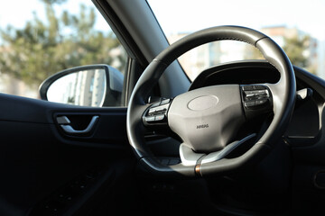 Black steering wheel inside of modern car