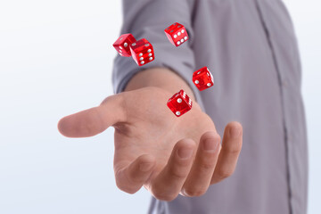 Man throwing red dice on white background, closeup
