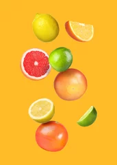 Poster Many different fresh citrus fruits falling on orange background © New Africa