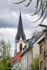 Fototapeta na wymiar St. Joseph's Church rises above the narrow, winding streets of Cologne's Ehrenfeld district