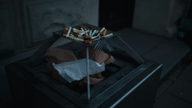 A tray of cigarettes rests on a table in a dimly lit room