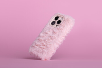 iPhone 15 Pro max in pink fluffy fur case falls down back view, phone case mockup with three...