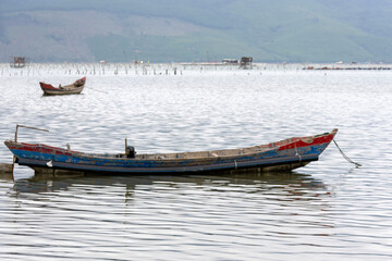 Traditional fishing boat in oyster farming industry in Lap An Lagoon, Vietnam - 778571438