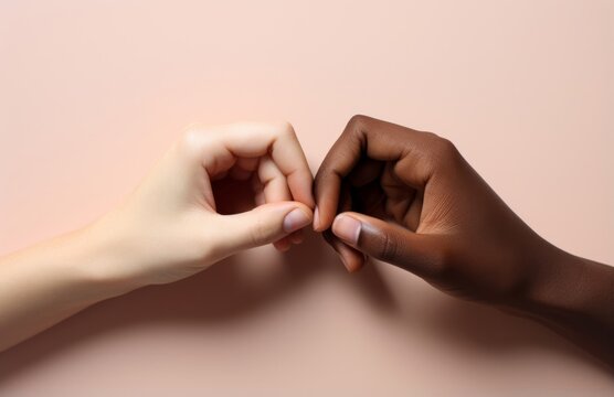 Hands of white and black people making a heart shape isolated on a pastel pink background shot in a studio for the concept of love and sharing. Generative AI.