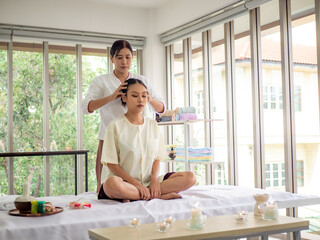 Young Thai woman relaxes with massage in spa