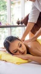 Obraz na płótnie Canvas Young Thai woman relaxes with massage in spa