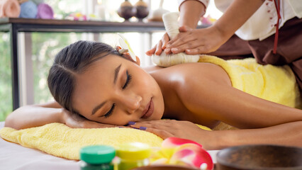 Young Thai woman relaxes with massage in spa