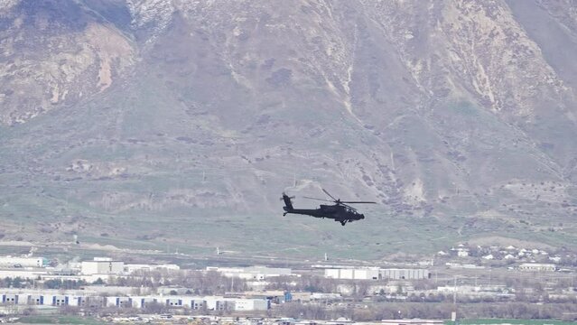 Boeing AH-64 Apache Helicopter flying through Utah Valley.