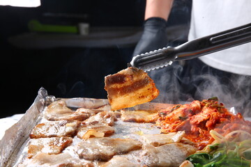 Pork belly that is cooked on a Korean-style grill