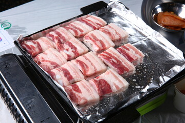 Pork belly that is cooked on a Korean-style grill