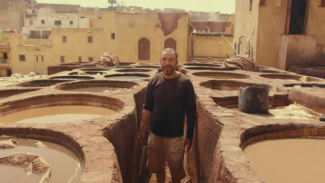 Moroccan tannery Worker looking at camera