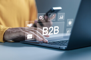 Fototapeta premium B2B marketing concept, business to business, e-commerce, businessman use laptop with B2B icons for professional business and commerce collaboration. business action plan strategy.