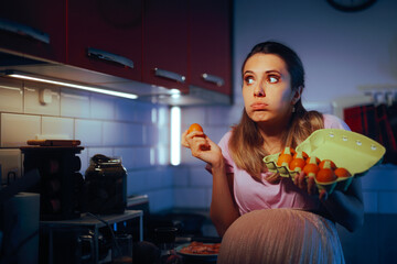 Pregnant Woman Holding a Egg Carton Wondering. Puzzled pregnant girl preparing breakfast thinking...