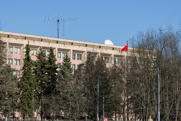 View of the building of the Embassy of the People's Republic of China. Moscow, Russia. Near the building there is a flagpole with the red flag of China.