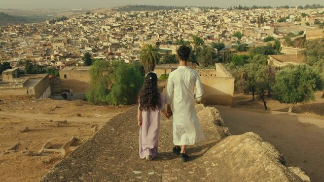 Kids Overlooking Old City of Fes in Morocco in traditional clothes