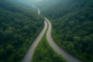 Aerial top view beautiful curve road on green forest in the rain foggy season.