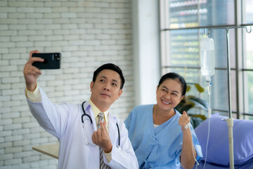 Doctor and nurse check patient's condition The symptoms of the illness are getting better and the patient is happy.
