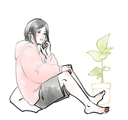 床に座ってスマホで話している女性