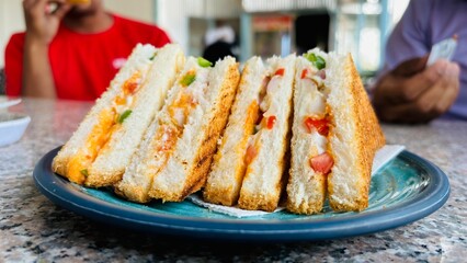 Healthy veg sandwich on wooden board with vegetables. Delicious vegetarian bread sandwich with herbs, onion, tomatoes, cheese and chilly
