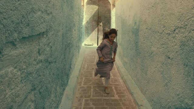 Little Girl playing Hop Scotch in an alley