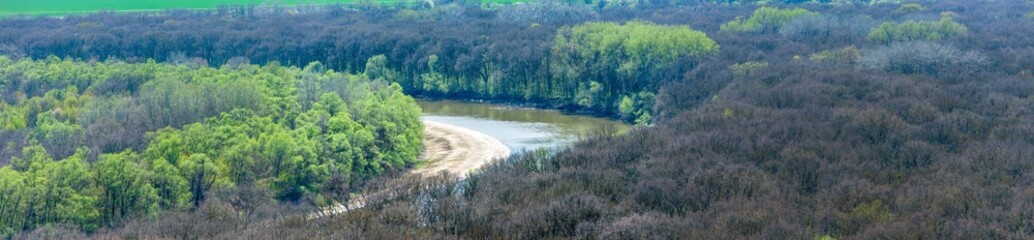 panorama of the bend of the Kuban River near the city of Ust-Labinsk (South of Russia) on a sunny day in early spring - obrazy, fototapety, plakaty