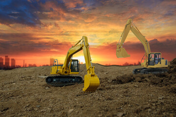 Crawler excavator with are digging the soil in the construction site on the sunset sky backgrounds