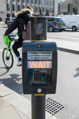 UK pedestrian crossing. Pedestrian crossing button showing WAIT sign on electronic monitor. London. UK.
