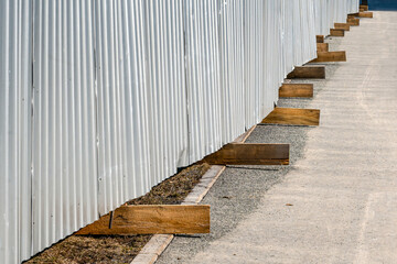 A fragment of a construction site fence on a spring day