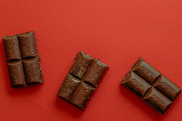 Chocolate bar pieces. Background with chocolate. Sweet food photo concept.