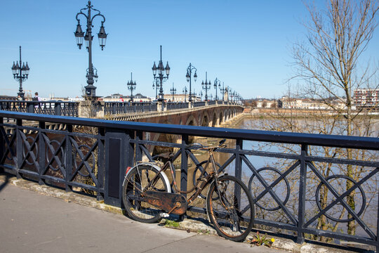 Bike locked to railing along Bordeaux quay near pont de pierre
