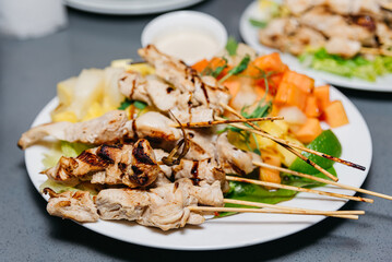 Grilled Chicken Skewers with Fresh Pineapple and Vegetables. Grilled chicken skewers paired with juicy pineapple chunks and fresh vegetables, an ideal choice for a healthy and flavorful meal.