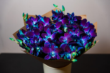 Vibrant Blue and Purple Orchid Bouquet. A stunning bouquet of blue and purple orchids wrapped in...