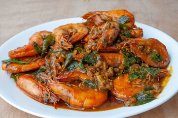 Kam Heong Prawns on white plate. Delicious Asian food concept