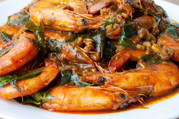 Close up of Kam Heong Prawns on white plate. Delicious Asian food concept