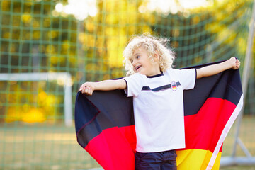 Germany football fan kids. Children play soccer.