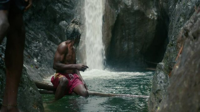 Rasta Men near a Waterfall Stream