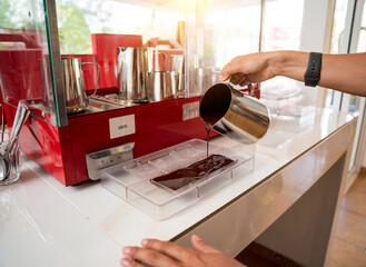 Young woman in the workshop during a lesson on making handmade chocolates and sweets